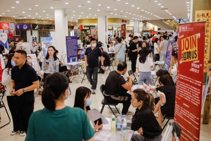 Job seekers and recruiters interact at a job fair in Beijing, China, 09 June 2023. Photo: EPA