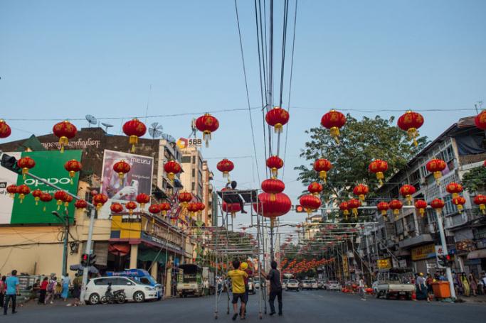 This photo taken on February 12, 2018 shows workers installing red lantern decorations in the streets of Yangon's Chinatown ahead of the Lunar New Year. Photo: Ye Aung Thu/AFP