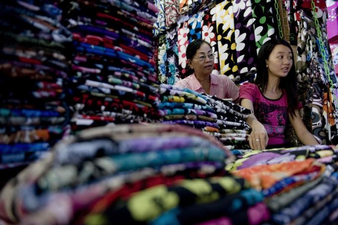 Chinese-Myanmar women as they sit in their fabric shop in the Chinese market in Mandalay. Photo: AFP
