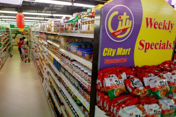 Customers shop for food products at the City Mart supermarket in Yangon. Photo: Lynn Bo Bo/EPA