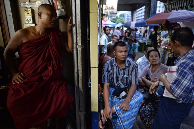 People waiting outside a private clinic in downtown Yangon. Photo: AFP
