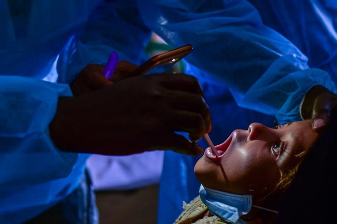 In this photograph taken on January 10, 2018, doctors from Médecins Sans Frontières (MSF) examine Rohingya Muslim refugee Mohammad Rashed, 11, and who is infected with diphtheria at the MSF field hospital in the Bangladeshi town of Thankhali. Photo: Munir Uz Zaman/AFP
