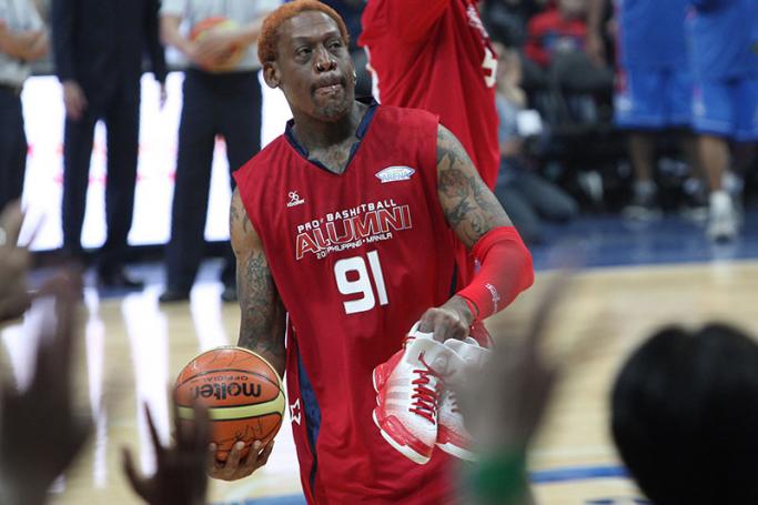 Former United States NBA player Dennis Rodman gestures to throw a ball with his autograph toward fans watching an exhibition game against Filipino players in Manila, Philippines 18 July 2012. Photo: EPA
