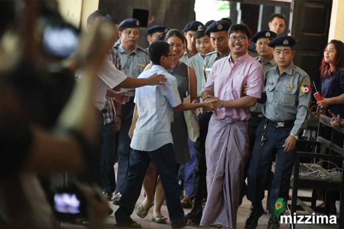 Detained Reuters journalists are escorted by police as they arrive at the court for their trial in Yangon on 16 May 2018. Photo: Thura/Mizzima
