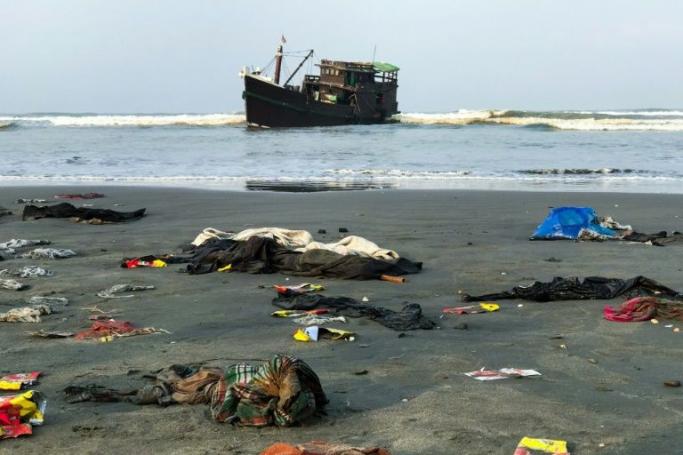 Belongings of Rohingya refugees lay on the shore as their carrier boat remains anchored nearby in Teknaf on 16 April 2020. Photo: AFP