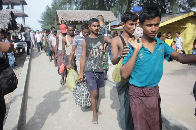 A group of Rohingya refugee make their way to a temporary shelter after landing in Aceh province on Sumatra island on April 20, 2018, just weeks after dozens of the persecuted Muslim minority from Myanmar came ashore in neighbouring Malaysia. Photo: Amanda Jufrian/AFP
