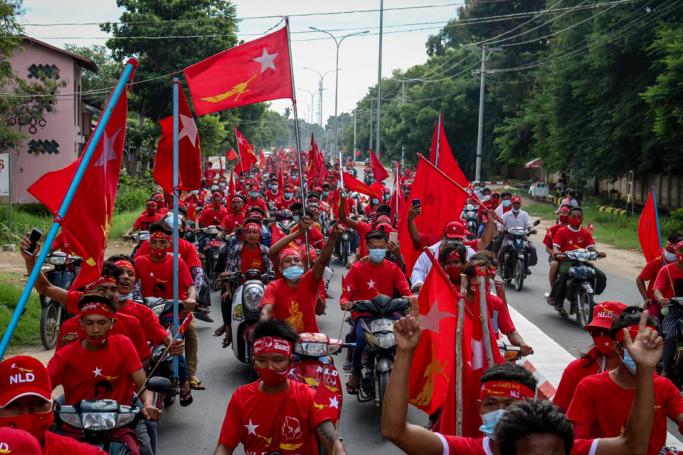 Supporters of the National League for Democracy (NLD) party ride a motorcade during a campaign in Wundwin, near Mandalay on September 19, 2020. Photo: Kyaw Thet Zin/AFP