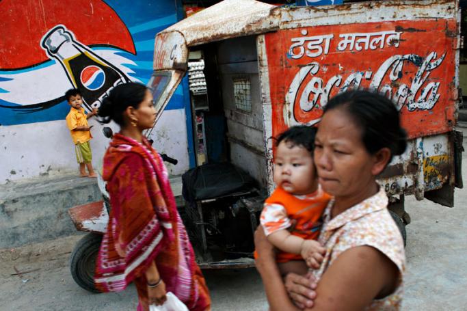 (File) Ethnic Chin refugees from Myanmar (L and R) are seen on a street alley in a suburb of New Delhi. Photo: AFP