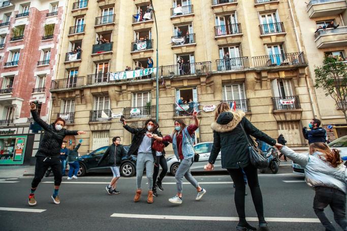  Residents of Saint Mande celebrate the end of containment measures in the street and thank medical and health care personnel amid the ongoing coronavirus COVID-19 pandemic in front of a building decorated with French flags and banners in Saint Mande, near Paris, France, 11 May 2020. Photo: EPA