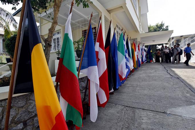 Local and international media members wait near the European countries flags to attend the opening ceremony of European Union office in Yangon, Myanmar, 28 April 2012.  Photo: Nyein Chan Naing/EPA
