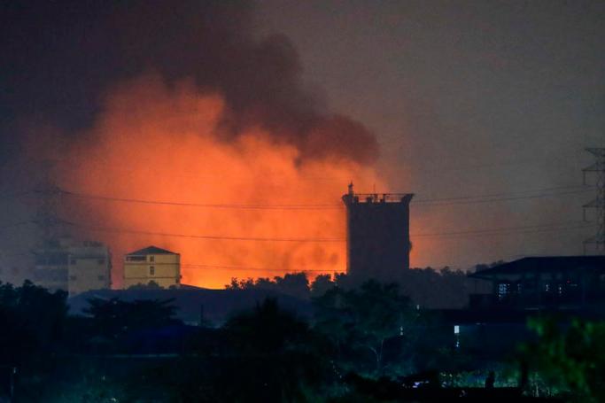 Fire from burning Chinese owned factories light up the industrial neighborhood in Hlaingthaya (Hlaing Tharyar) Township, outskirts of Yangon, Myanmar, 15 March 2021. Photo: EPA