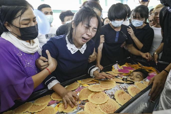 The mother (C-L) and the father (C-R) of Khant Nyar Hein, an eighteen-year-old medical student who was shot dead during a protest against the military coup, mourn over their son's body during a funeral service in Yangon, #Myanmar, 16 March 2021. Photo: EPA