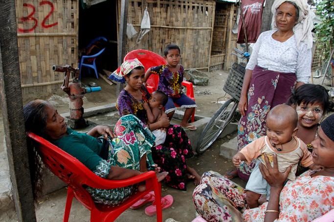 Rohingya family members gather in front of their hut in an Internally Displaced Persons (IDPs) camp near Sittwe, Rakhine State, western Myanmar, 22 March 2016. Photo: Nyunt Win/EPA
