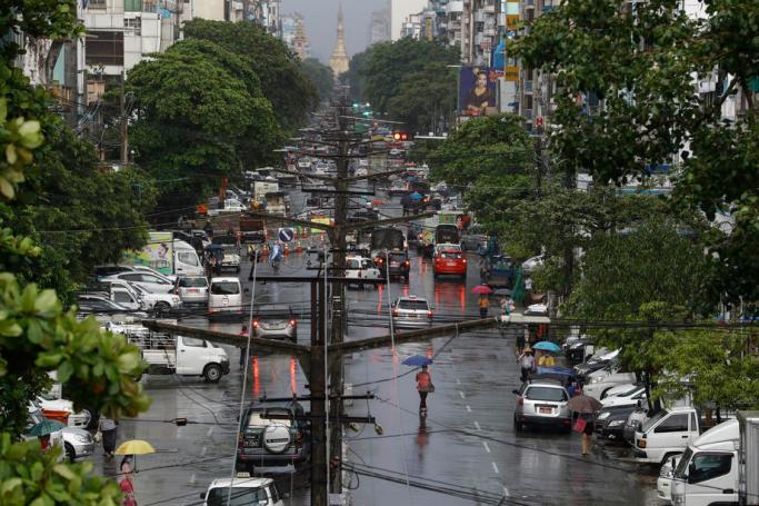 Electric poles and cables are seen along the road ahead of Sule pagoda at downtown area in Yangon. Photo: Lynn Bo Bo/EPA