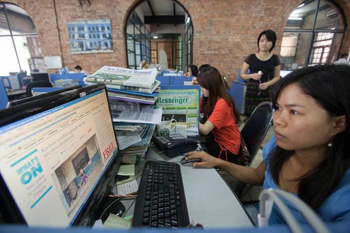 Journalists at work in the news room of of Myanmar Times weekly journal, Yangon, Myanmar. Photo: Lynn Bo Bo/EPA
