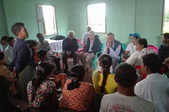 Mr. Filippo Grandi. the UN High Commissioner for Refugees, centre, with hands folded, meets with villagers in Maungtaw Township yesterday. Photo: MNA

