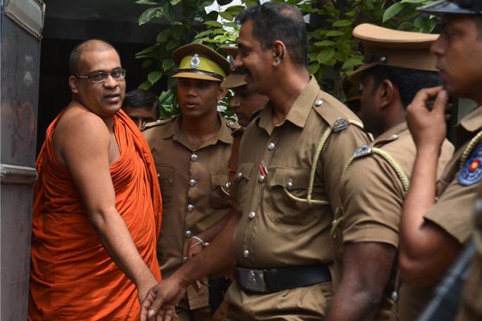 (File) In this file photo taken on June 14, 2018 Sri Lankan guards escort firebrand Buddhist monk Galagodaatte Gnanasara after he was sentenced to six months in jail by a magistrate in Homagama. Sri Lanka's president ignored requests on February 4, 2019 to free a jailed firebrand Buddhist monk even as 518 other convicts were released to mark the independence day. Photo: Lakruwan Wanniarachchi/AFP
