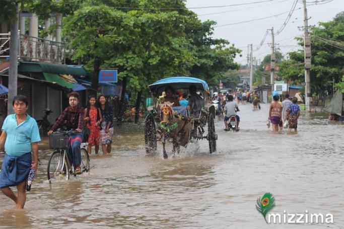 Residents walk in the flooded township of Mawlamyine district in Mon state on June 18, 2018. Photo: Thet Ko/Mizzima
