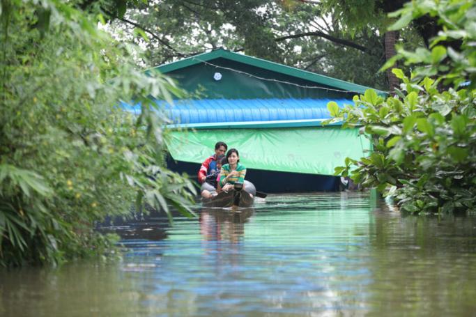 People travel through floodwaters in the Bago region, Myanmar. Photo: Thura/Mizzima
