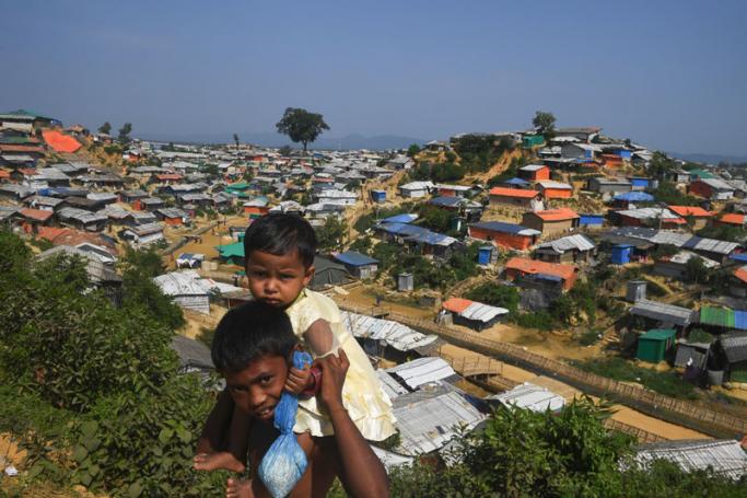 Young Rohingya refugees look on as a general view of Balukhali refugee camp is pictured in Ukhia. Photo: Dibyangshu Sarkar/AFP