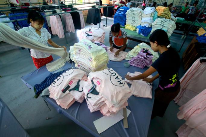 Girls work in a garment factory at Hlaing Thar Yar Industrial Zone in Yangon, Myanmar, 10 July 2015. Photo: Lynn Bo Bo/EPA
