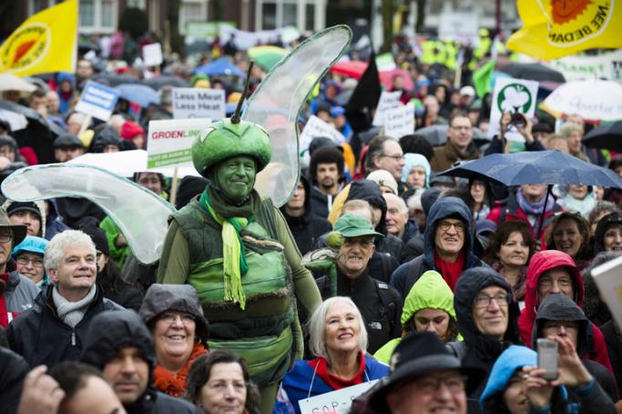 A man is dressed up in green during the Amsterdam's Global Climate March which saw a few thousand protesters calling on world governments to reach a climate deal, Amsterdam, The Netherlands, 29 November 2015. Photo: Bart Maat/EPA

