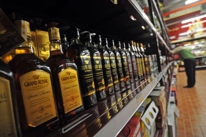Bottles of "Grand Royal Whisky" are pictured on a shelf at a wholesale market in Yangon. Photo: AFP
