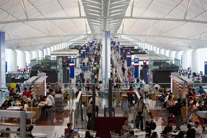 Travelers walk to their boarding gates in Hong Kong International Airport in Hong Kong, China. Photo: EPA
