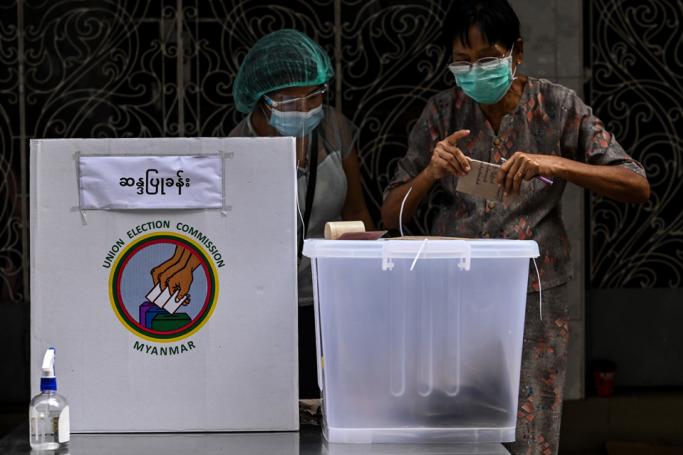 A woman votes at a polling station in Yangon on October 29, 2020, as advance voting in the country's elections began for elderly people. Photo: Ye Aung Thu/AFP