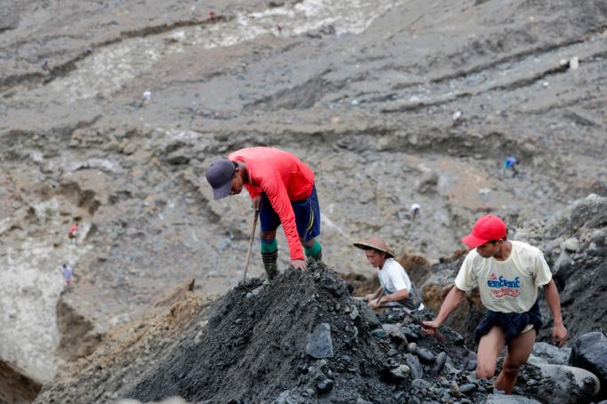 Miners search for jade stones at the HpaKant jade mining area, Kachin State, northern Myanmar. Photo: Nyein Chan Naing/EPA