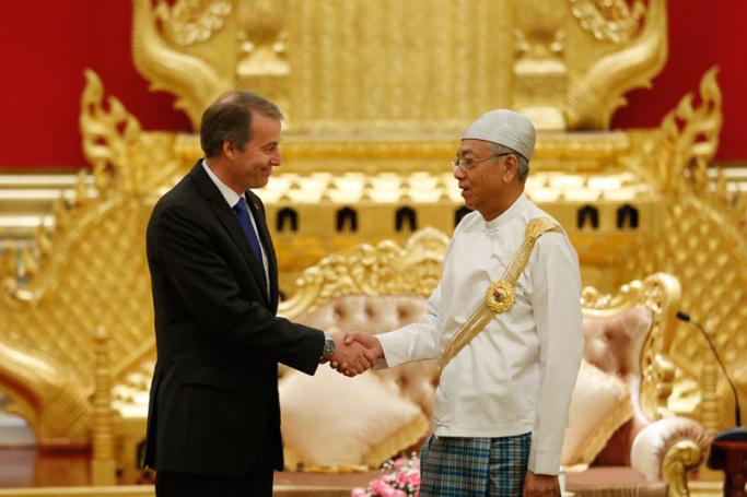 Myanmar's President Htin Kyaw (R), shakes hands with Kristian Schmidt (L), newly-accredited Ambassador of European Union (EU), during a reception for accredited ambassadors to Myanmar, at the President House in Naypyitaw, Myanmar, 17 October 2017. Photo: Hein Htet/EPA-EFE
