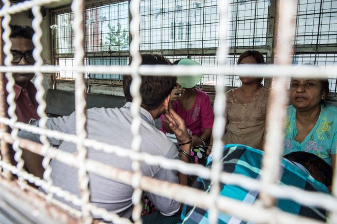(File) Six detained Myanmar family members facing charges of human trafficking are transported in a prison van following their trial in Yangon on October 13, 2016. Photo: AFP