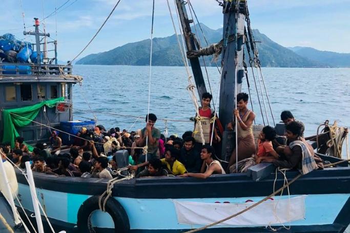 A wooden boat carrying suspected Rohingya migrants is shown detained in Malaysian territorial waters off Langkawi island, on April 5, 2020 (AFP Photo/Handout) 
