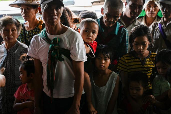 This photo taken on August 25, 2019 shows people, affected by clashes between the military and ethnic rebel groups, waiting to receive supplies from local civil society organisations in Man Lwal village, outside Kutkai in Shan State. Photo: Ye Aung Thu/AFP