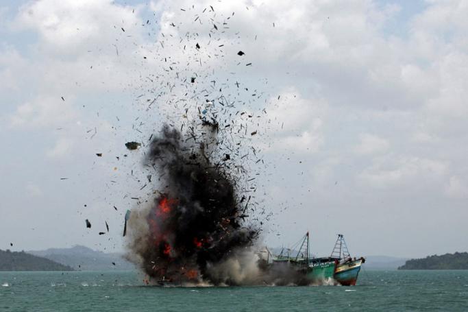 Indonesia Navy blows up a foreign fishing vessel caught fishing illegally in Indonesian sea, at Batam Sea, Indonesia, 22 February 2016. Photo: M URIP/EPA

