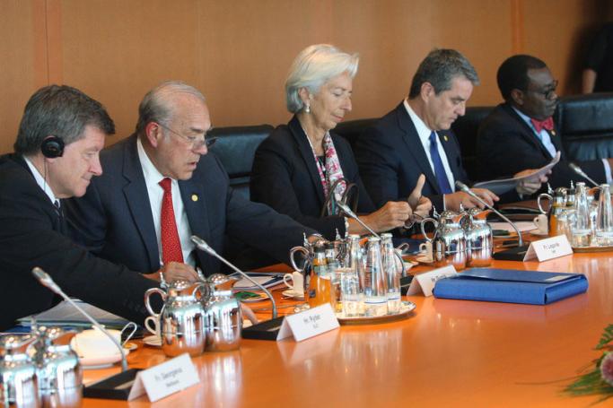 ILO Director-General Guy Ryder, OECD Secretary General Angel Gurria, IMF Managing Director Christine Lagarde, WTO chairman Roberto Azevedo and AfDB President Akinwumi Adesina prepare their documents prior to a meeting with German Chancellor Merkel (unseen) and leaders of economic and financial organizations, such as the International Monetary Fund (IMF), the World Bank, the Organisation for Economic Co-operation and Development (OECD), the World Trade Organization (WTO), the International Labour Organizatio