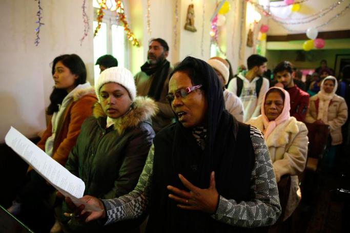 People pray as they attend Christian prayers at the Holy Family Catholic Church on Christmas in Srinagar, Indian Kashmir, 25 December 2019. Photo: Farooq Khan/EPA