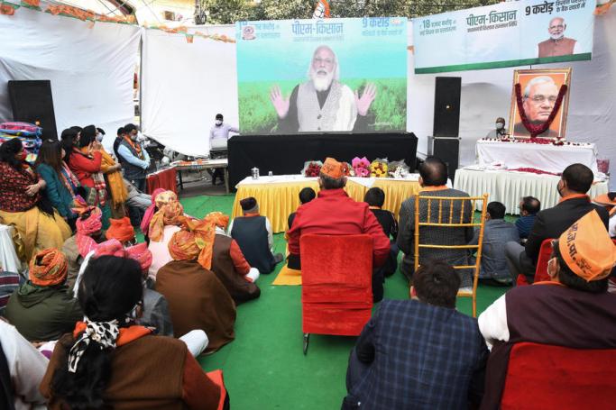 People listen as Indian Prime Minister Narendra Modi delivers a virtual address to the farmers of six states on the occasion of birth anniversary of former Indian prime Minister Atal Bihari Vajpayee, in New Delhi, India, 25 December 2020. Photo: EPA