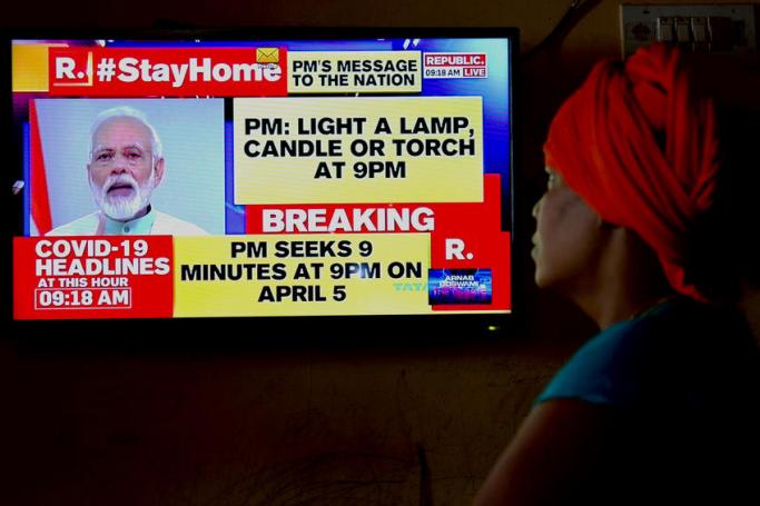 A man listens to Indian Prime Minister Narendra Modi talking on national TV about the ongoing lockdown amid the coronavirus pandemic, in Bangalore, India, 03 April 2020. Photo: EPA