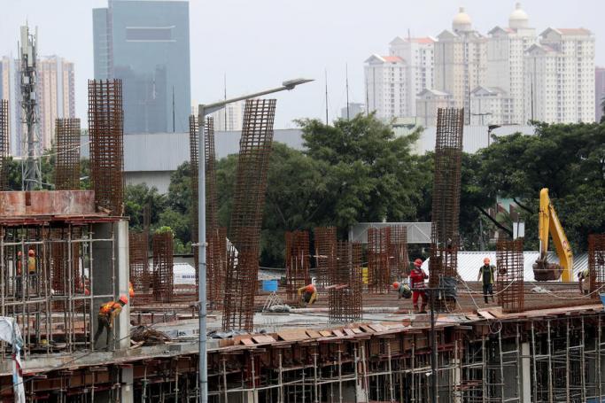 Workers at a construction site in Jakarta, Indonesia, 30 January 2021. Photo: EPA