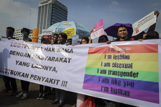 (File) LGBT (lesbian, gay, bisexual, and transgender) and woman's rights activists hold a banner during a protest against the draft of the country’s new criminal code (RKUHP) outside the parliament building in Jakarta, Indonesia, 12 February 2018. Photo: EPA