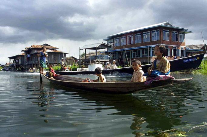 Children from Myanmar's Intha tribe sail on a flat-bottomed boat in the famous Inle Lake situated in north-eastern Shan State. Photo: AFP
