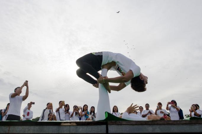 Participants perform yoga at a park in Yangon on June 21, 2018 to celebrate the International Yoga Day. Photo: Ye Aung Thu/AFP

