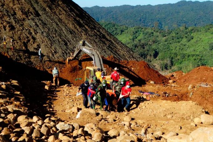 Soldiers and rescue workers carry the body of the miner killed by landslide at Hpa Kant jade mining area, Kachin State, northern Myanmar, 22 November 2015. Photo: MWD Daily News/EPA
