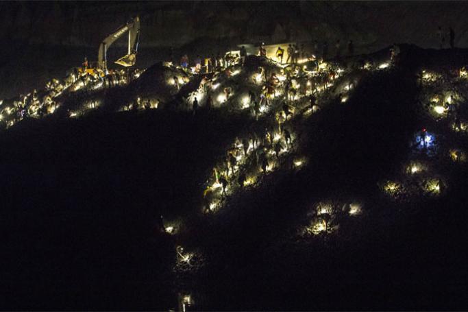 The sun may set, but the mine still teems with workers throughout the night. Photo: Minzayar
