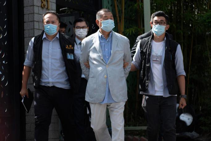 Jimmy Lai (C), media tycoon and founder of Apple Daily, is escorted by police after he was arrested at his home in Hong Kong, China, 10 August 2020.  Photo: EPA