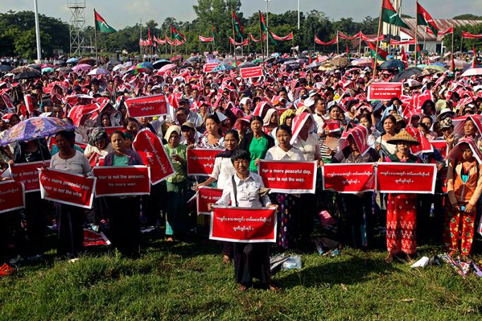 Kachin people hold placards reading 'For a more peaceful day, war is not the way.' and 'Stop civil war in Kachin State' during a protest held to show opposition to the conflict between the Myanmar Army and Kachin Independence Army (KIA) in Kachin State, in Myitkyina, Kachin State, Myanmar, 3 October 2016. Photo: Seng Mai/EPA

