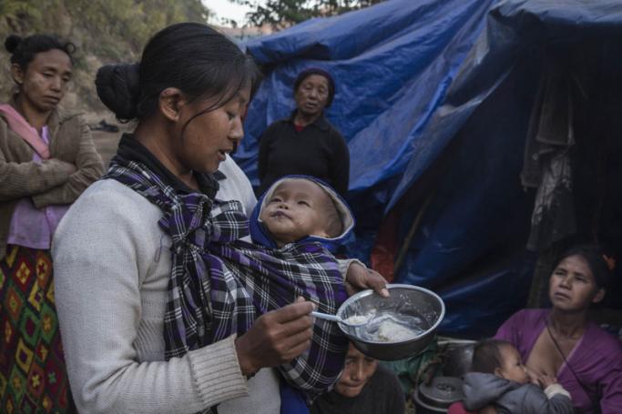 A mother feeding her baby at a refugee camp near Lung Byeng village, Waimaw township in Kachin state. Photo: Hkun Lat/AFP
