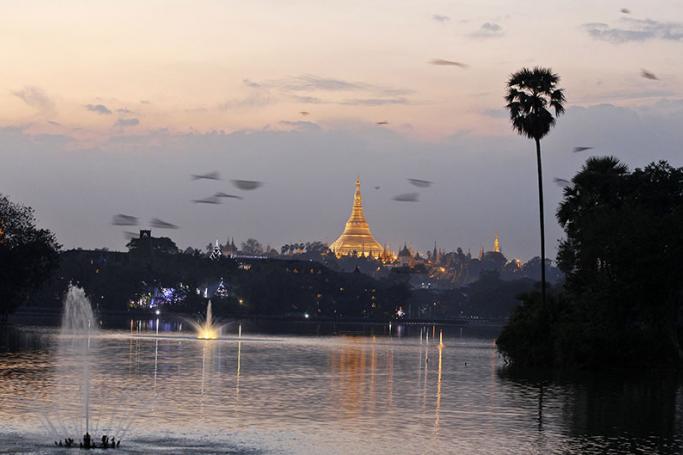A view of sunset over the Shwedagon pagoda as seen from the Kandawgyi Park in Yangon. Photo: Nyein Chan Naing/EPA
