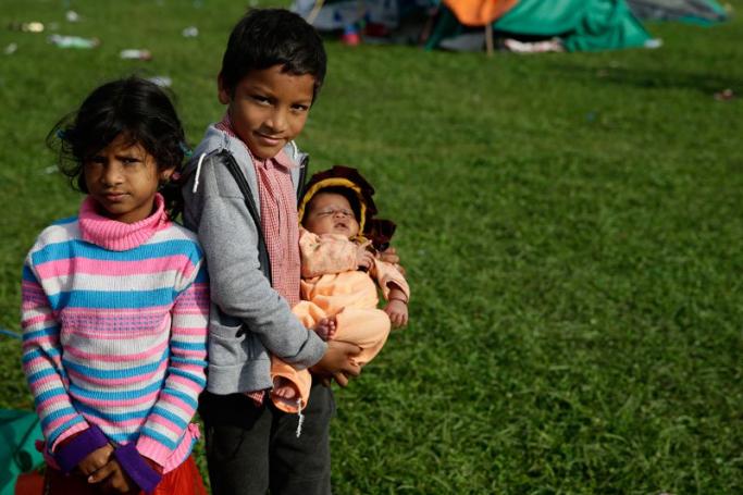 Children near their temporary tent on open ground in Kathmandu after a powerful earthquake followed by strong aftershocks struck Nepal, in Kathmandu, Nepal, April 27, 2015. Photo: Narendra Shrestha/EPA 
